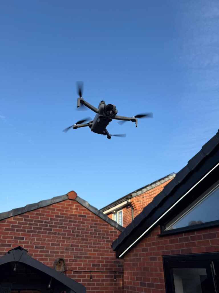 Survey drone in flight over a house roof
