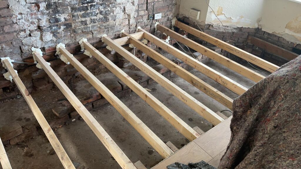 New floor joists fitted after timber treatment