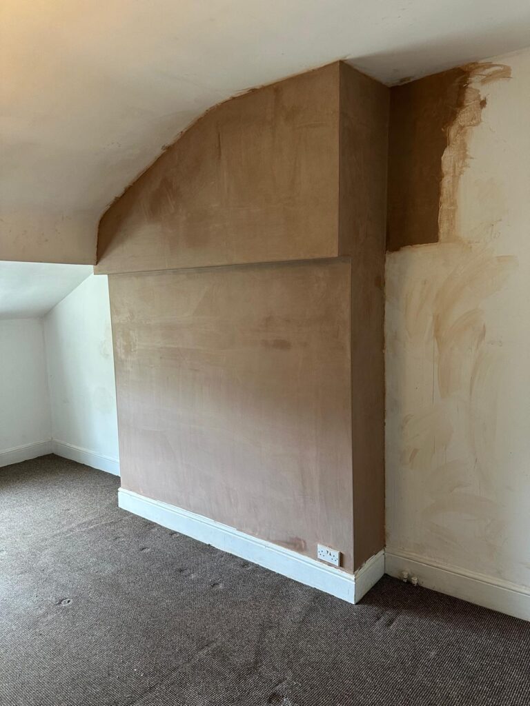 Newly plastered chimney breast wall